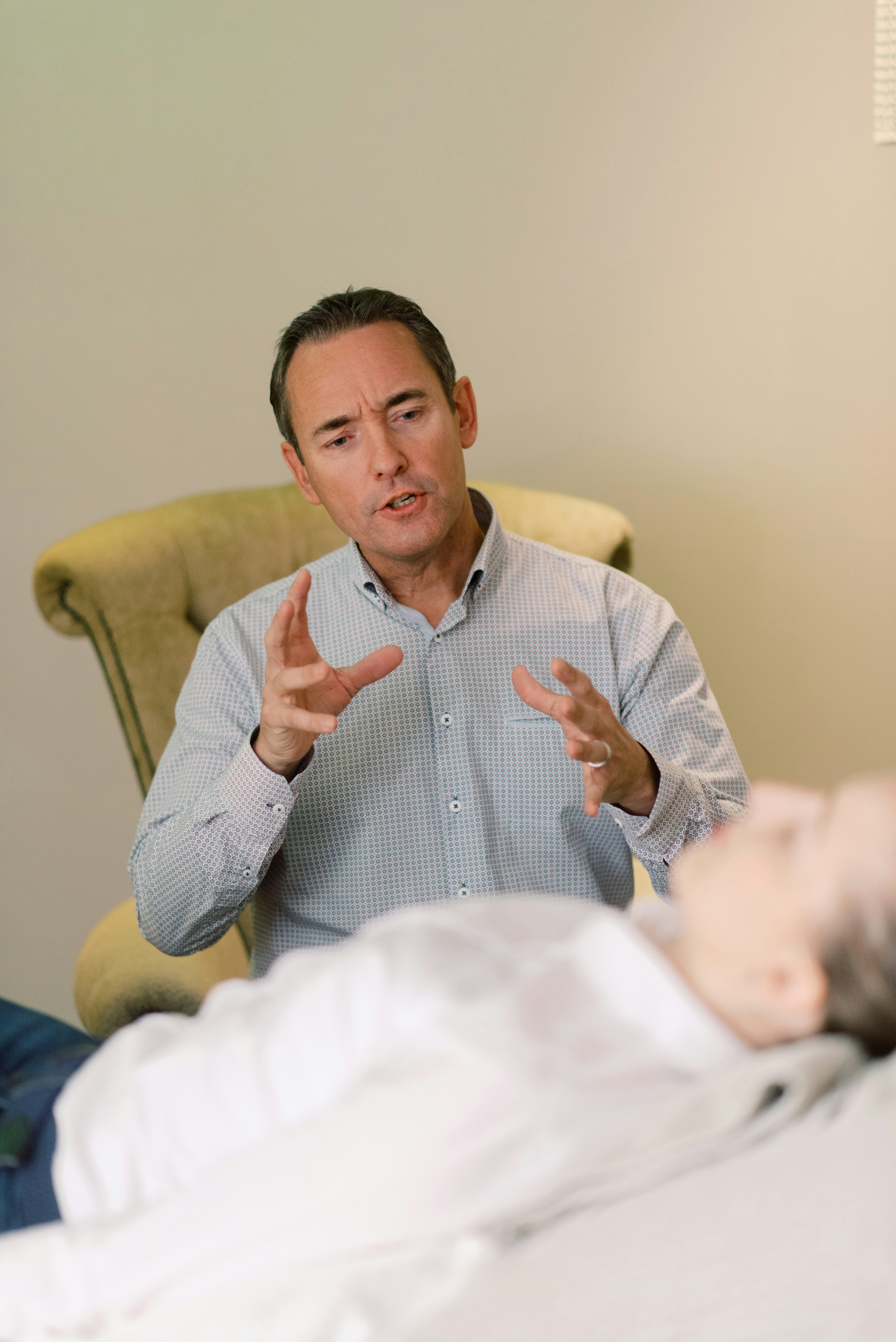 Therapist talking with a client during a one-on-one session in a calm office.