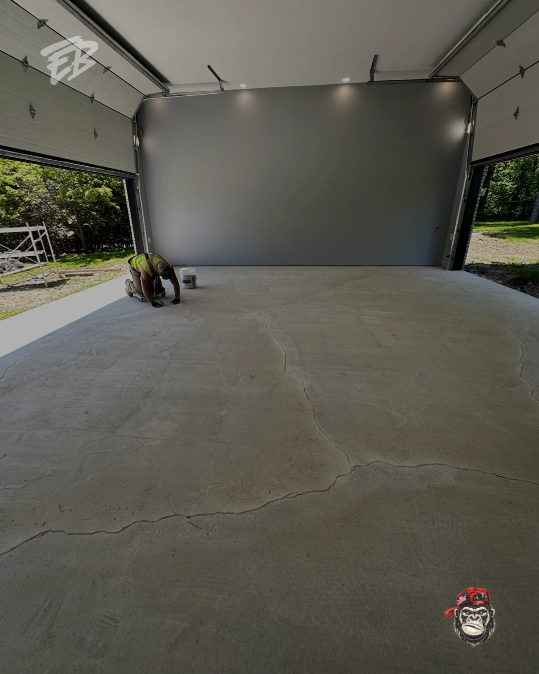 Garage floor before coating installation in Davie Florida showing visible concrete cracks and surface wear.