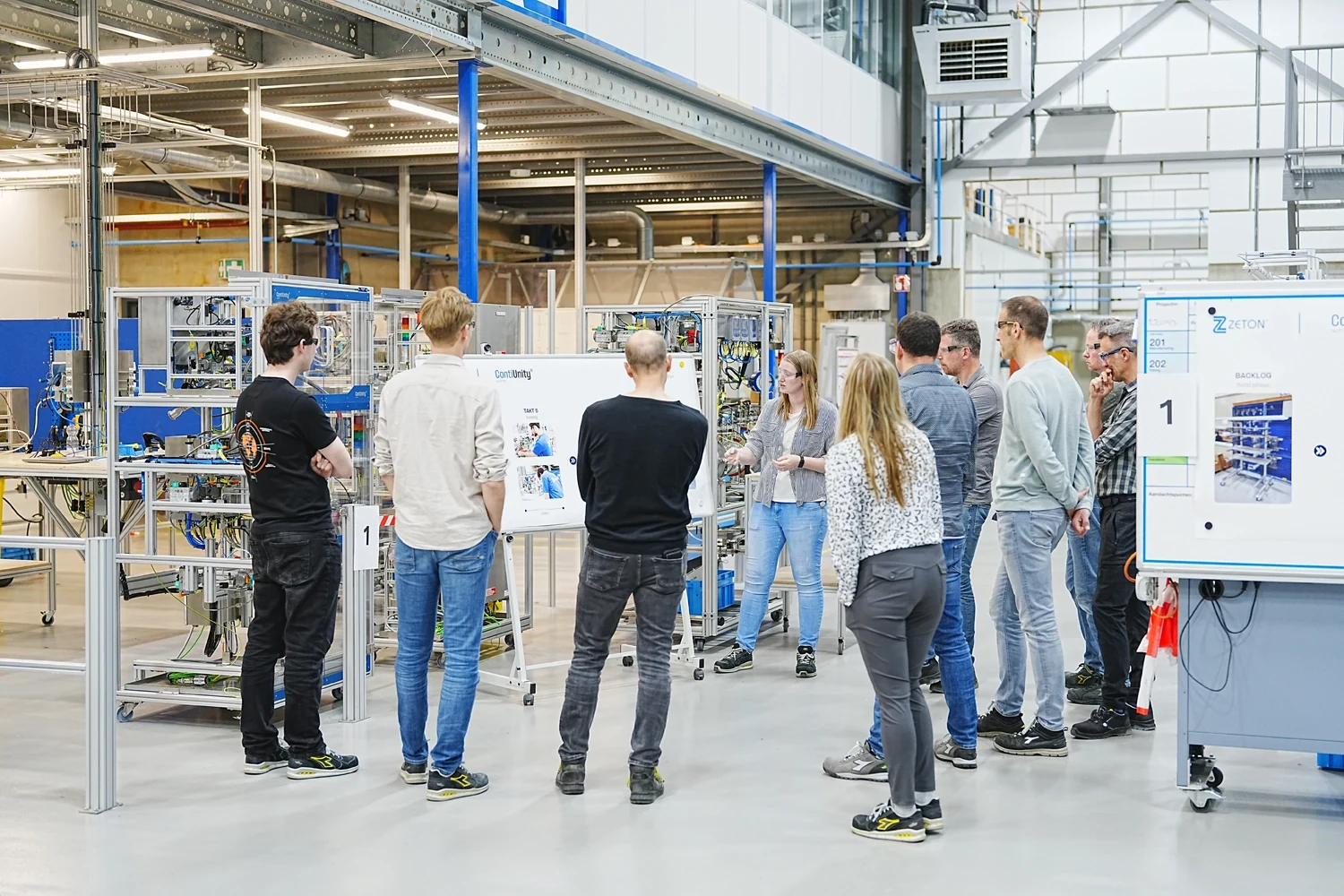 Cross-functional project team reviewing progress and system status during delivery of a ContiUnity continuous manufacturing project.