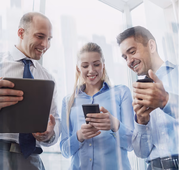 Colleagues reviewing content together on phones and a tablet
