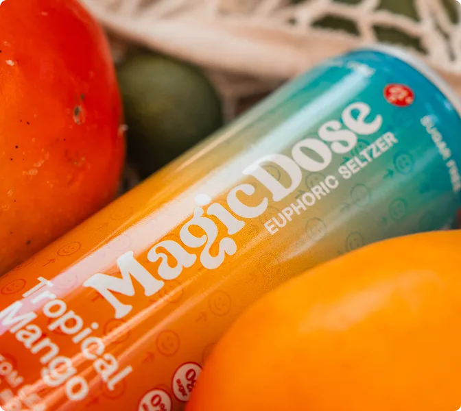 Close-up of a Magic Dose Tropical Mango can with oranges