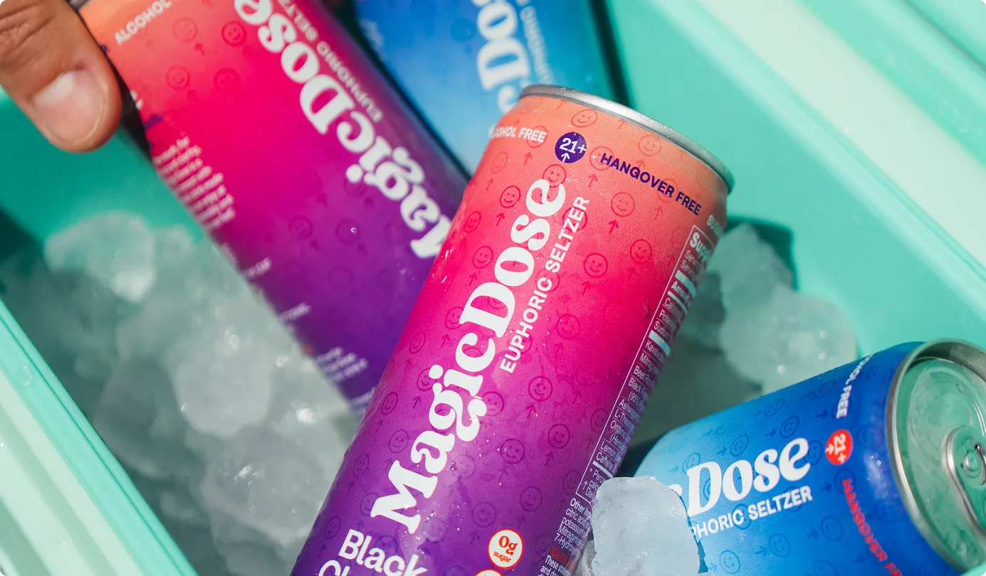 Magic Dose cans on ice in a cooler