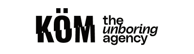Logo KÖM the unboring agency in black text on white background.