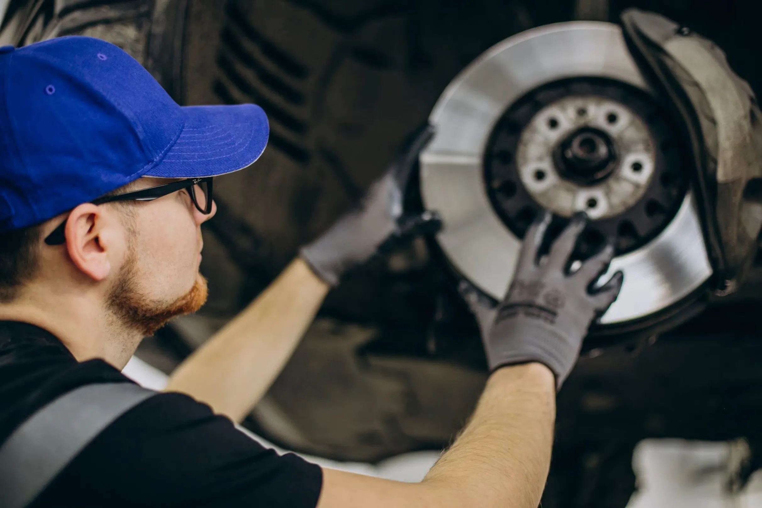 A mechanic doing a brake inspection at an Aussie Tune Workshop in Dandenong