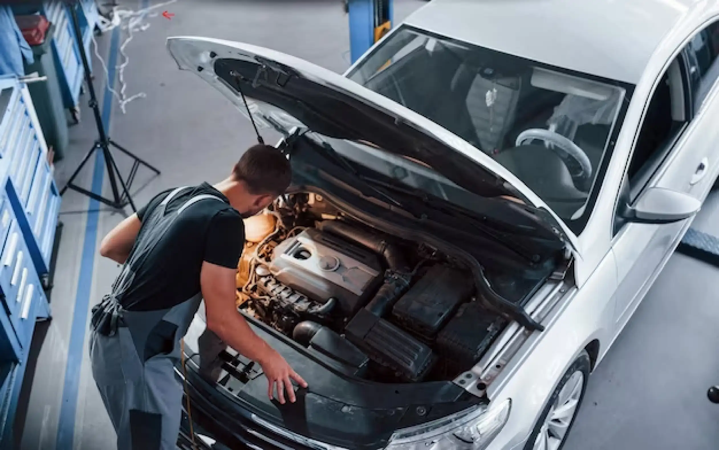 A qualified mechanic at Aussie Tune performing a scheduled logbook service on a BMW using genuine parts and advanced diagnostics.
