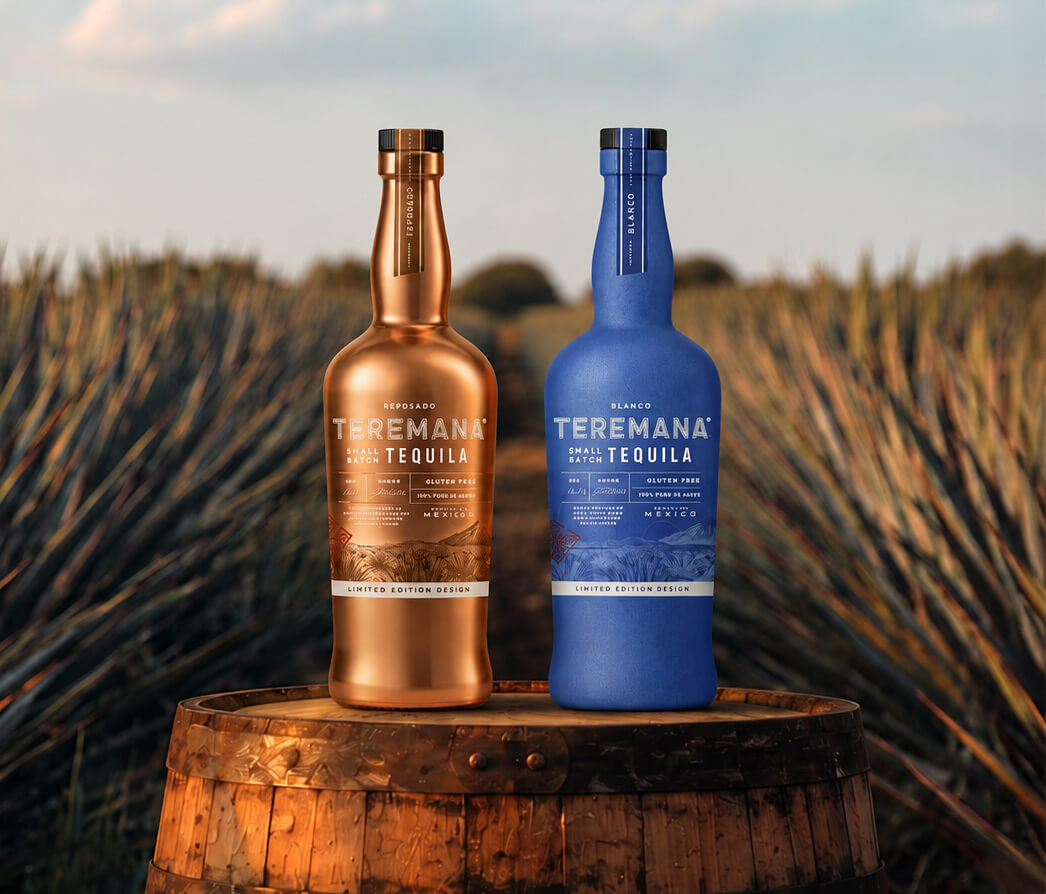 Copper and blue Teremana tequila bottles on a wooden barrel with agave plants in the background.