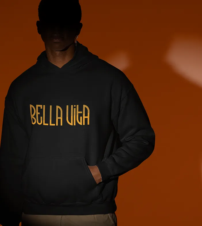 A man wearing a black hoodie with yellow text 'BELLA VITA' on orange background.