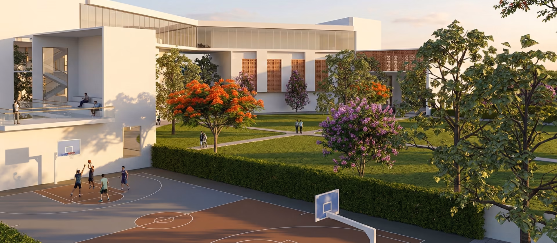 Modern campus building with students playing basketball and walking on green lawns with flowering trees.