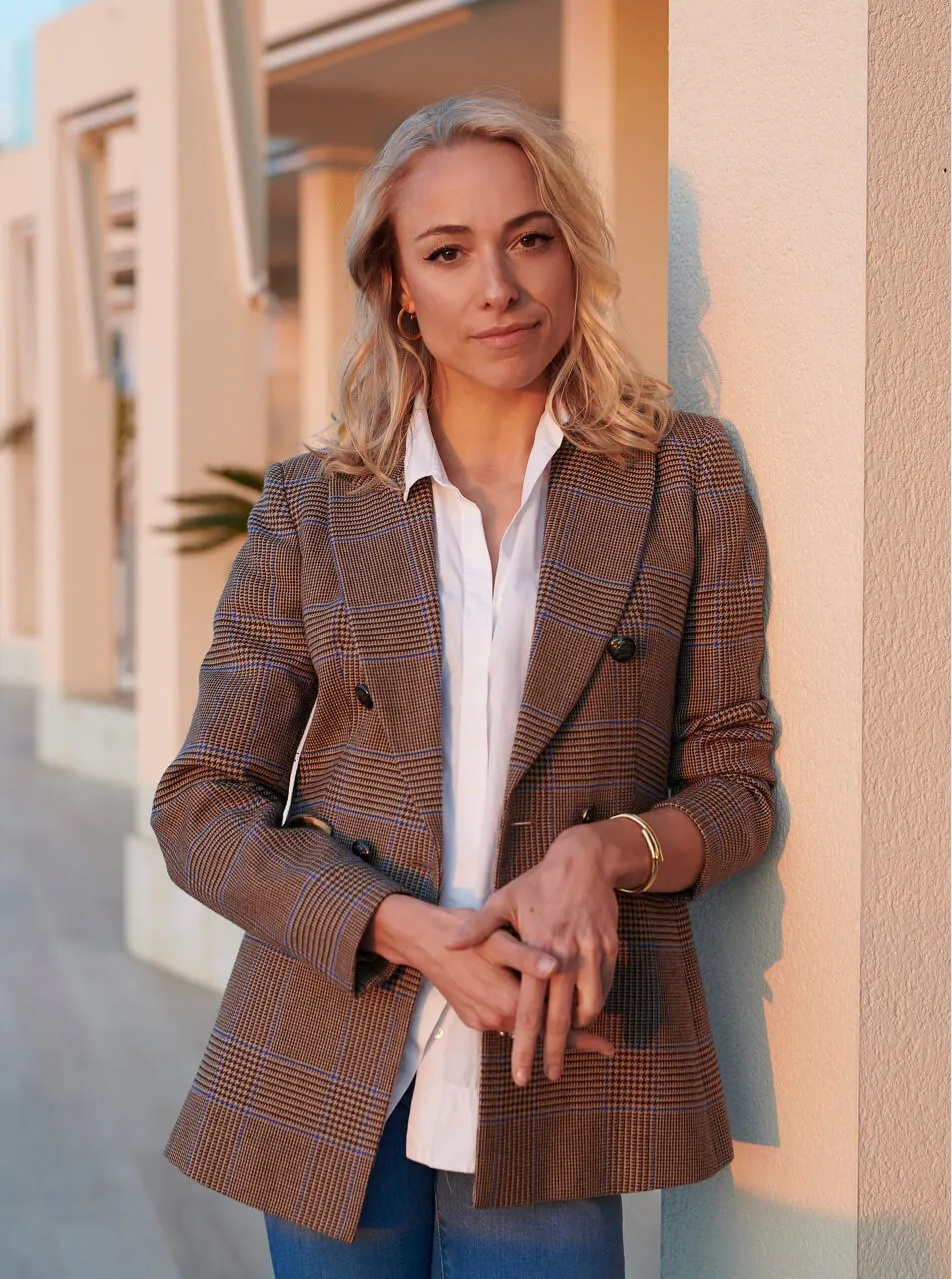 Portrait of Ivanka Moravová, founder and luxury interior designer at Studio Moravová in Ibiza, standing in warm sunlight.