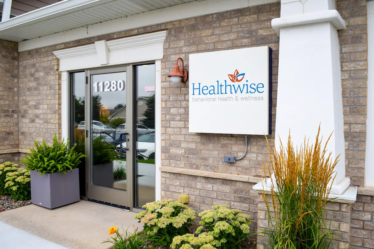 Exterior of Maple Grove Office: brick building with landscaping and a sign: Healthwise Behavioral Health and Wellness