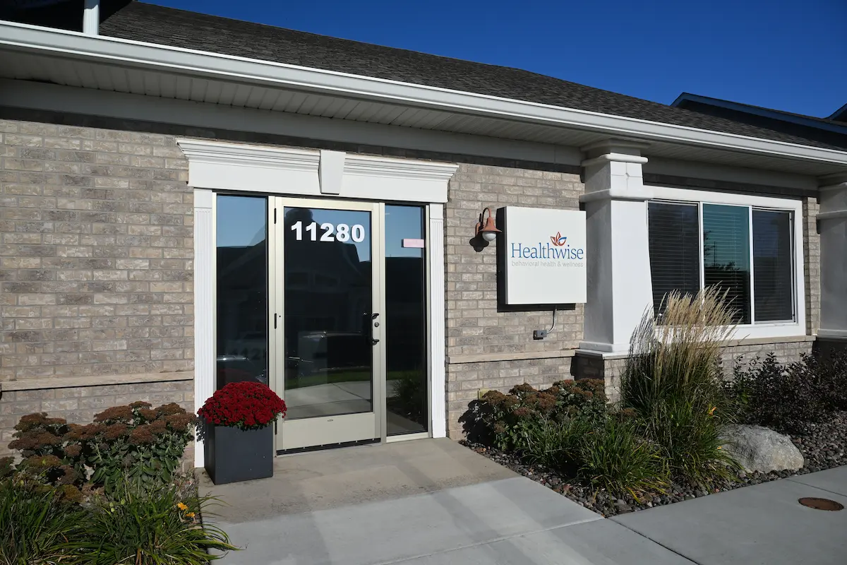 Exterior of Maple Grove Office: Brick building with glass door and landscaping