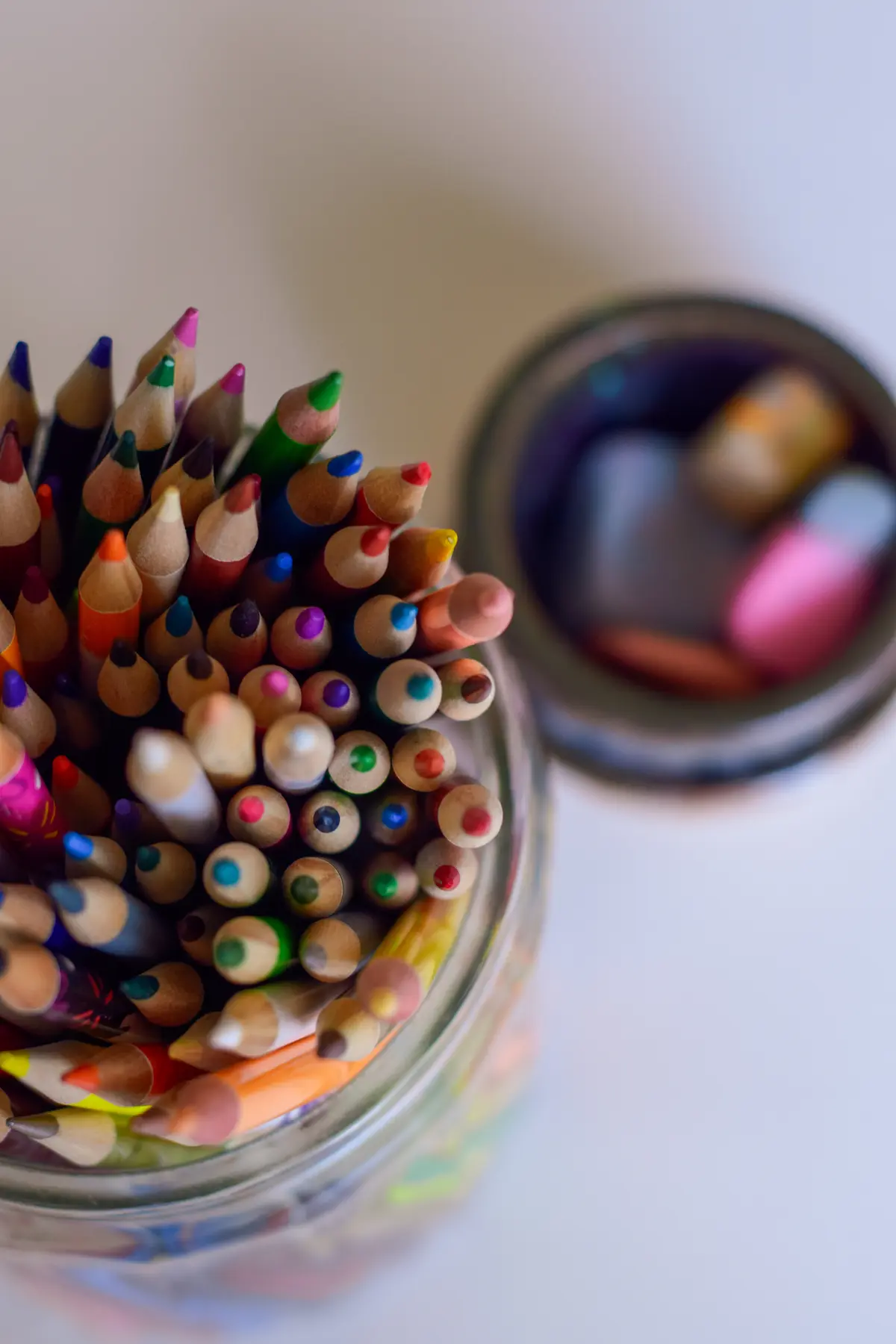 Containers with colored pencils and chalk