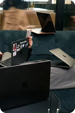 FlowMelon team working on laptops in a co-working space