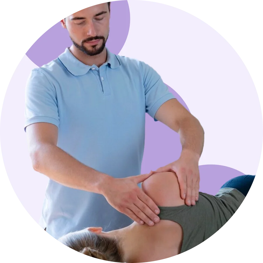 Physical therapist performing manual shoulder therapy on a patient lying on a treatment table