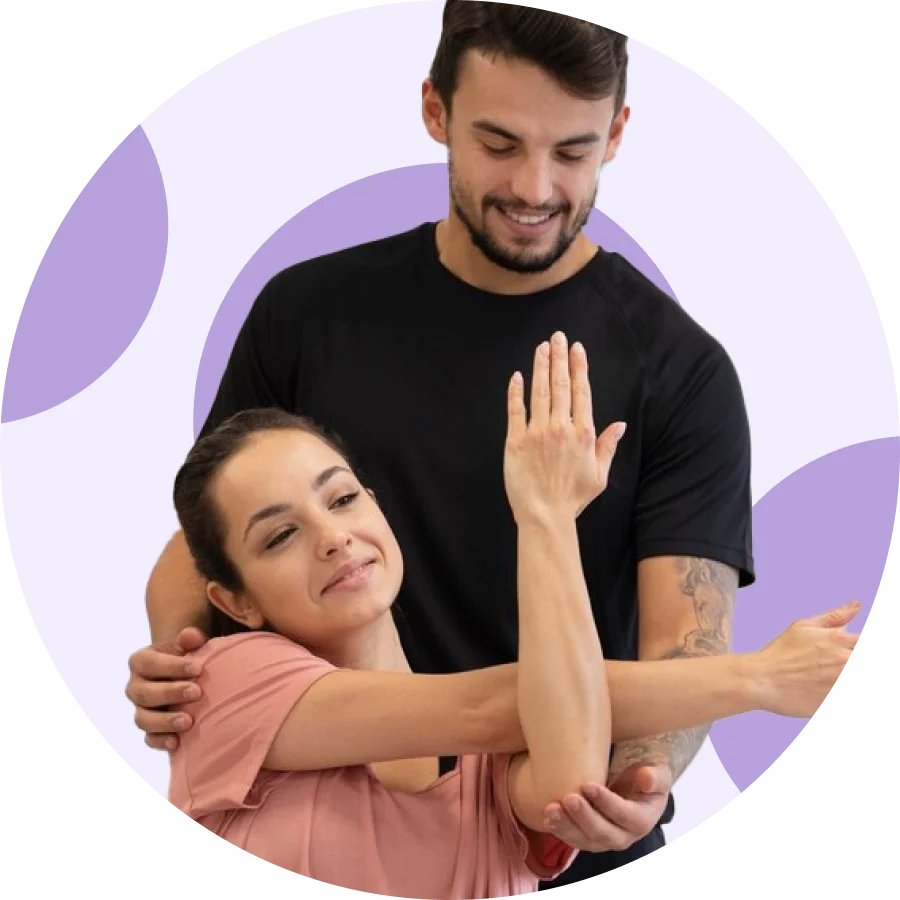 Physical therapist guiding a smiling patient through a cross-body shoulder stretch
