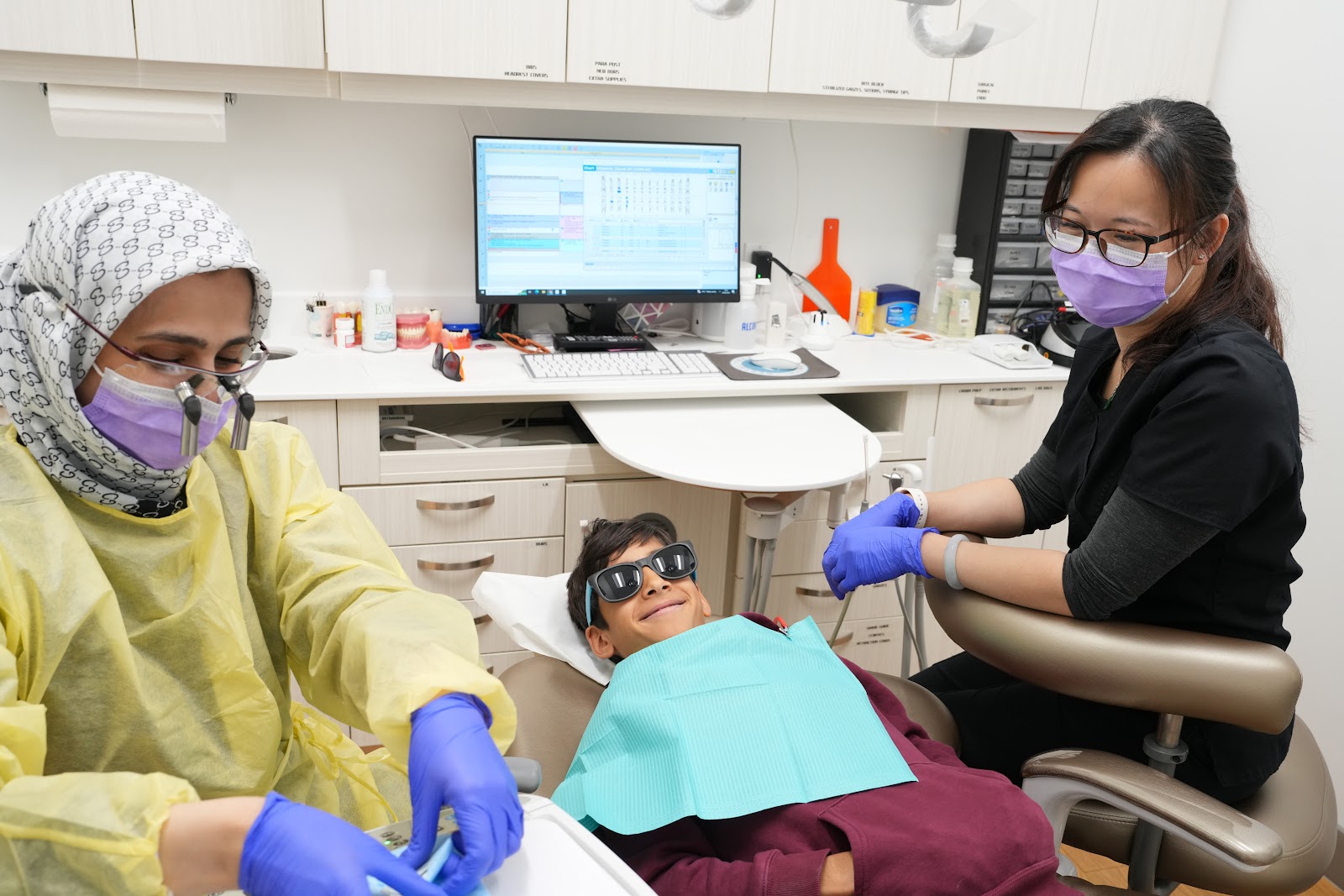 DTC Richmond dental clinic team assisting a young patient during a dental examination, showcasing a