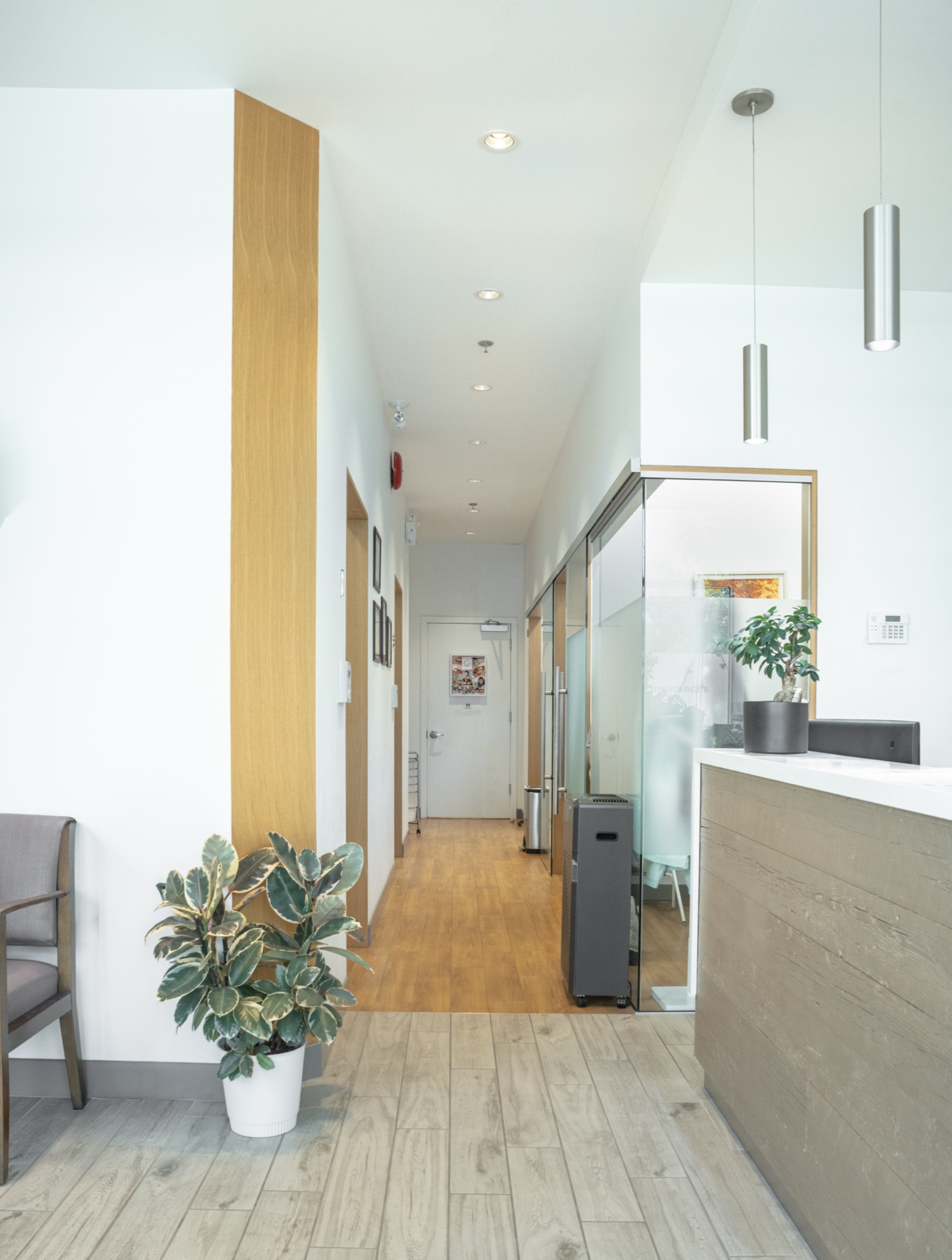 Bright and welcoming hallway inside DTC Dental Treatment Center in Richmond, BC, showcasing a modern,