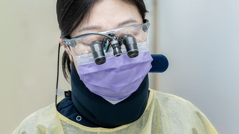 Dental hygienist with magnifying loupes at DTC Dental Treatment Center in Richmond, BC