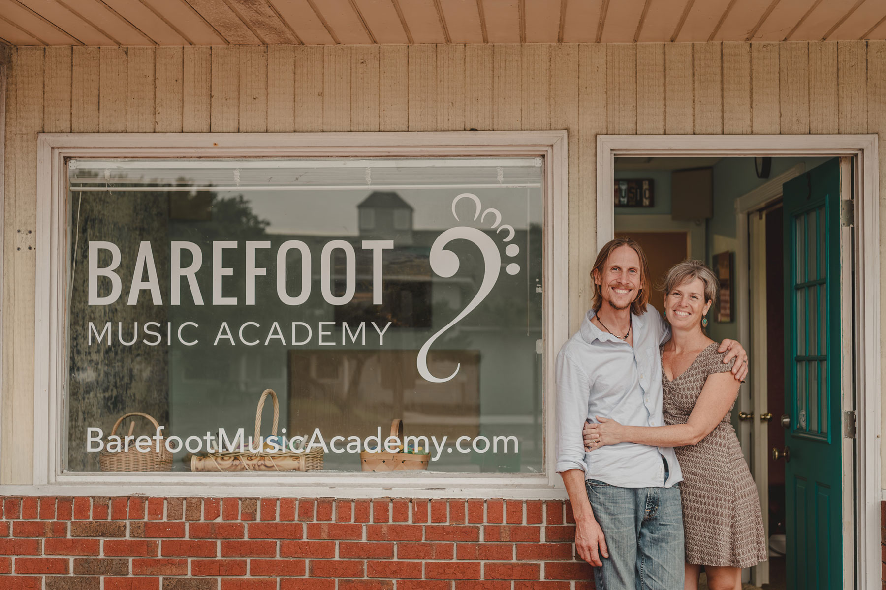 Matt and Erin Fleckenstein standing in front of the Barefoot Music Academy Studio