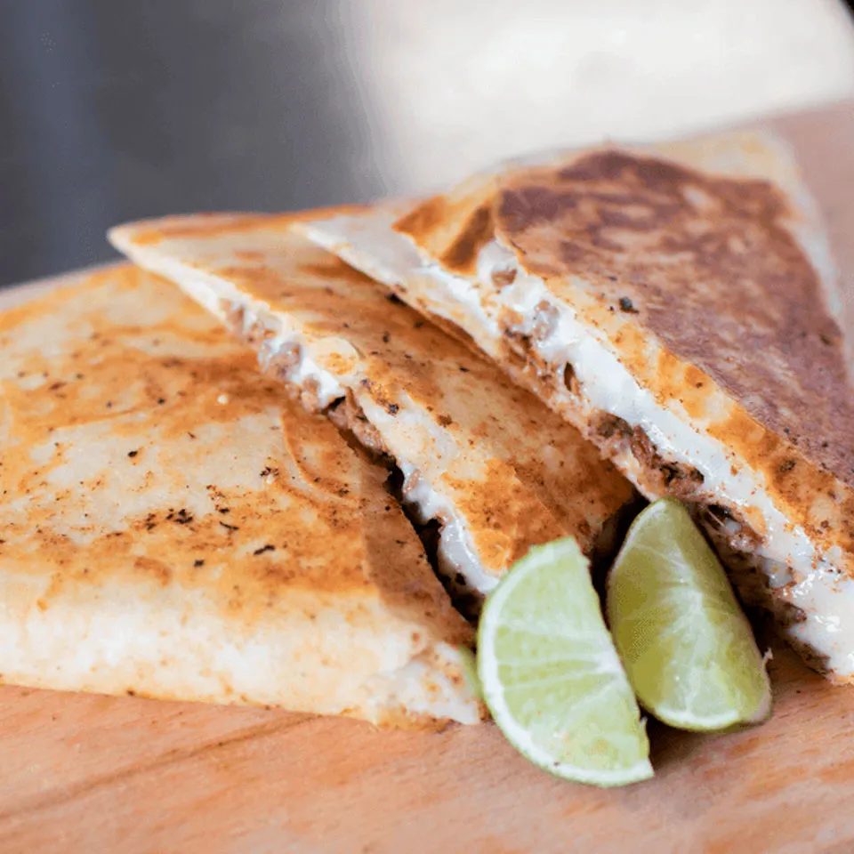 Gringa served with fresh lime wedges