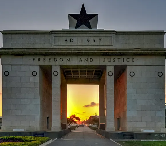 The Independence Arch with a black star and 'Freedom and Justice' at sunset in Accra, Ghana.