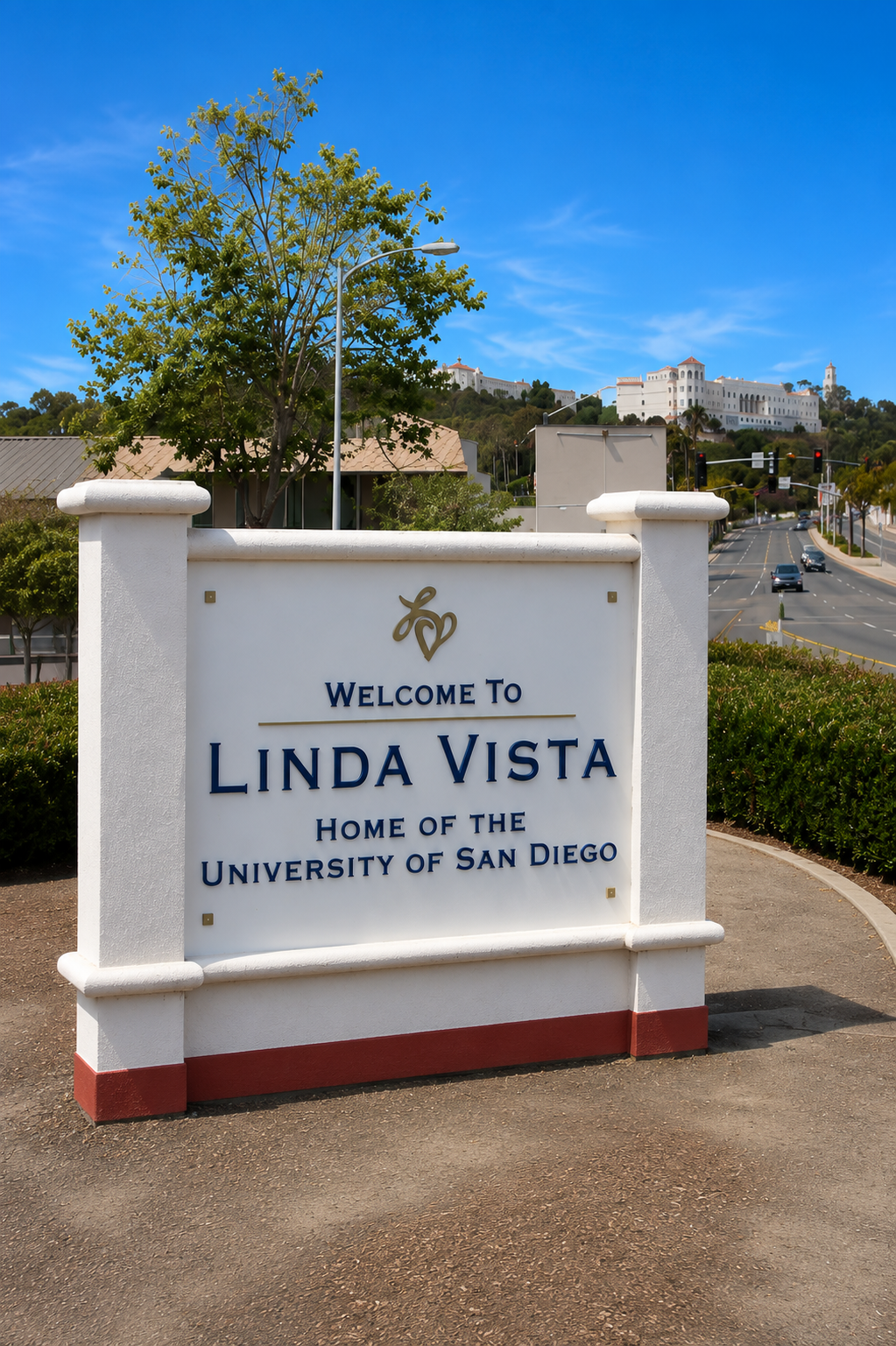 Welcome sign for Linda Vista, home of University of San Diego, with campus buildings in the background.