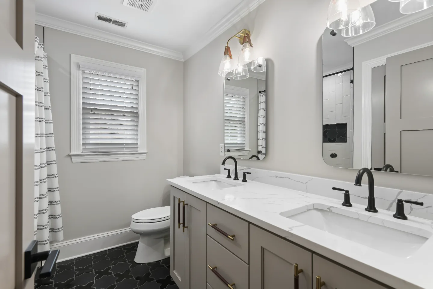 Guest Bath remodel in Watkins Creek, TN. Sebring Design Build designed this Watkins Creek guest bath (HIS) in Franklin, Tennessee with paint-grade Dune cabinetry, Mikado Calacatta Tree quartz.