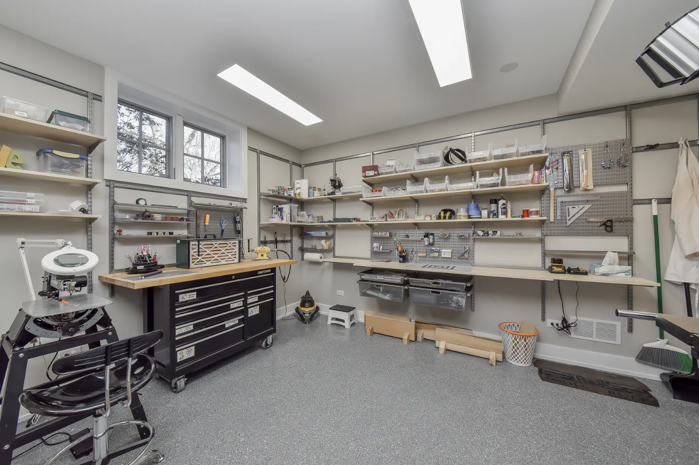 Workshop remodel in Franklin, TN. Sebring Design Build finished this Franklin basement workshop with a concrete floor finish built for real work: durable, honest to the space's purpose.