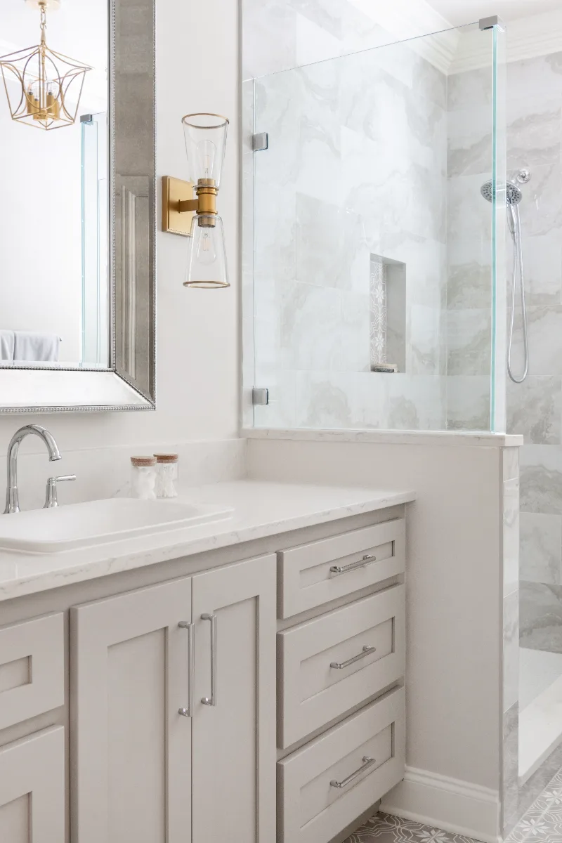 Primary Bath remodel in Cool Springs, TN. Sebring Design Build transformed this Cool Springs primary bath in Franklin, Tennessee with Shaker Recessed Square Dune cabinetry, Metro Quartz Mystique Square Edge countertops.
