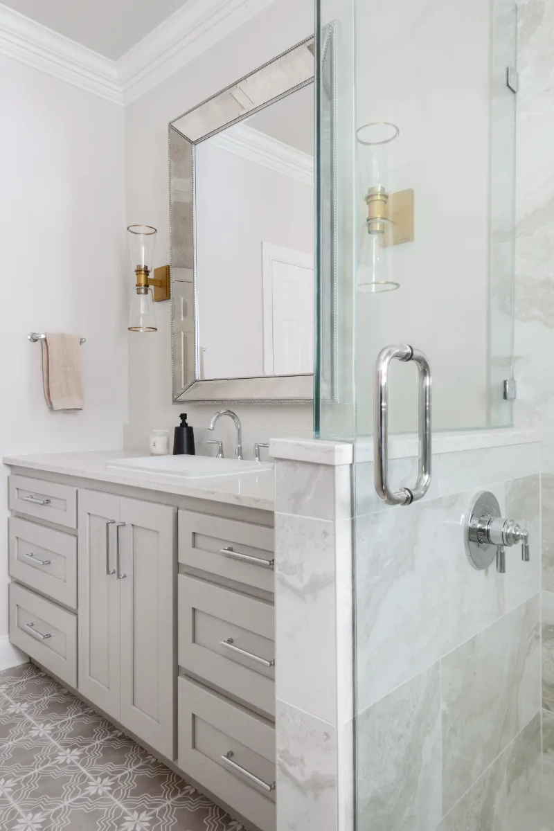 Primary Bath remodel in Cool Springs, TN. Sebring Design Build transformed this Cool Springs primary bath in Franklin, Tennessee with Shaker Recessed Square Dune cabinetry, Metro Quartz Mystique Square Edge countertops.