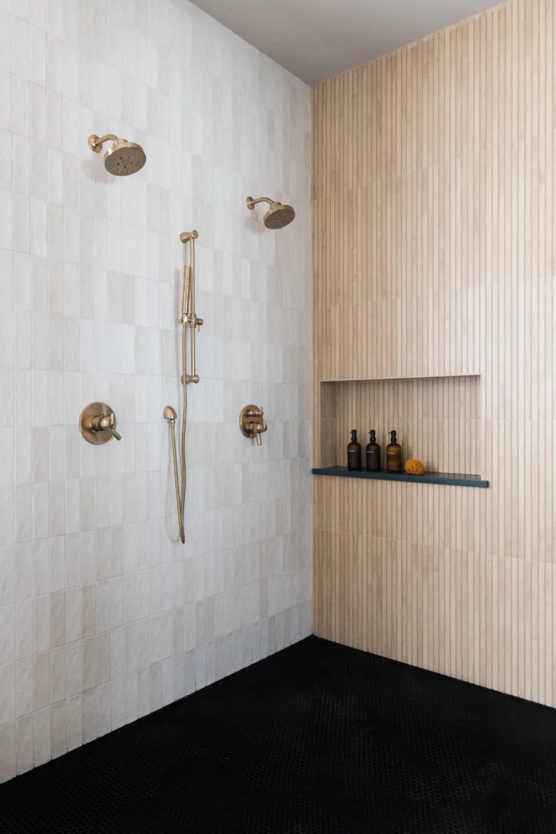 Primary Bath remodel in Columbia, TN. Sebring Design Build transformed this Columbia, Tennessee primary bath with Walnut Natural Slab cabinetry with horizontal grain in a matte finish.