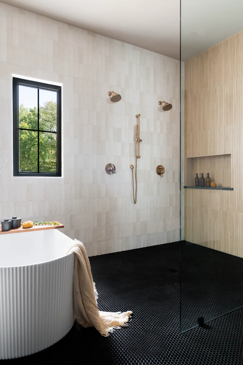 Primary Bath remodel in Columbia, TN. Sebring Design Build transformed this Columbia, Tennessee primary bath with Walnut Natural Slab cabinetry with horizontal grain in a matte finish.