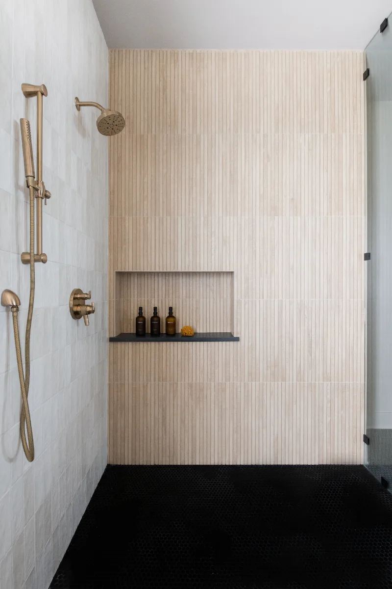 Primary Bath remodel in Columbia, TN. Sebring Design Build transformed this Columbia, Tennessee primary bath with Walnut Natural Slab cabinetry with horizontal grain in a matte finish.