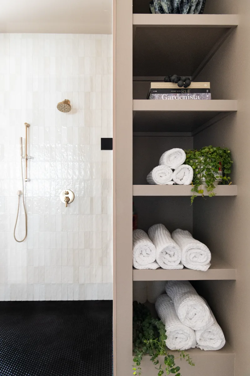 Primary Bath remodel in Columbia, TN. Sebring Design Build transformed this Columbia, Tennessee primary bath with Walnut Natural Slab cabinetry with horizontal grain in a matte finish.