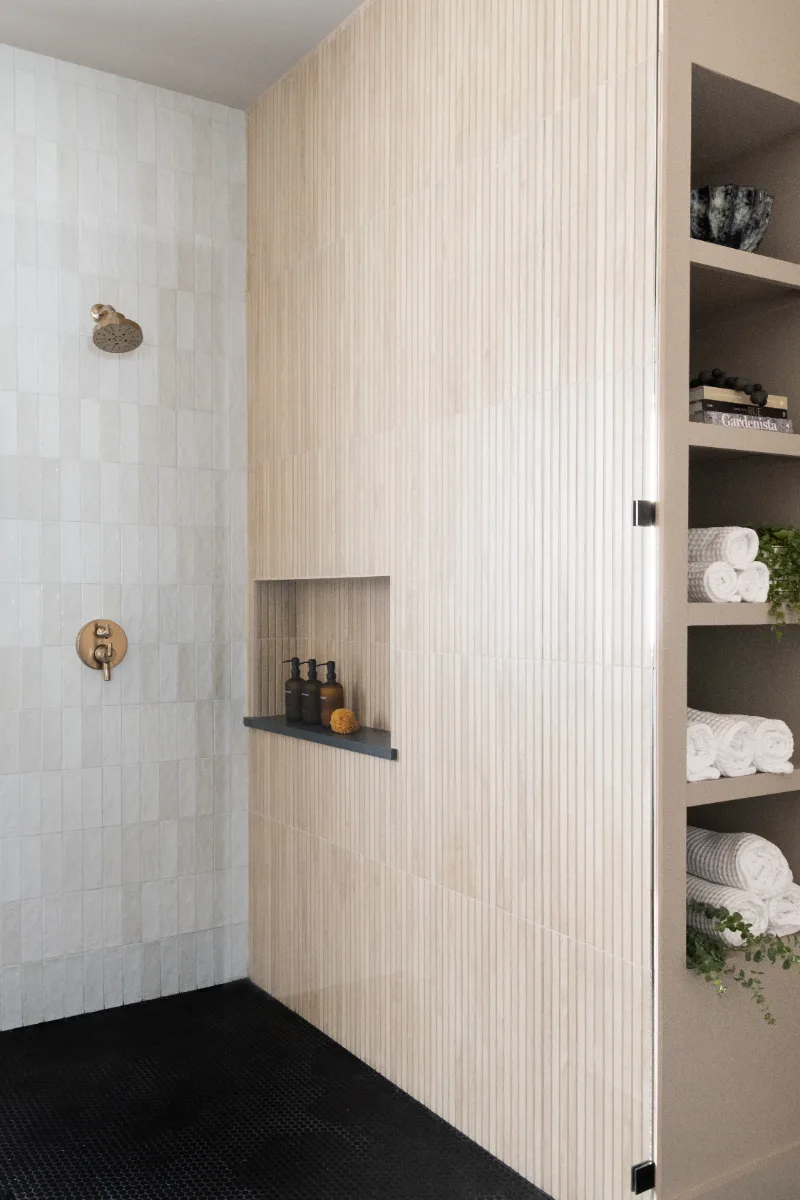 Primary Bath remodel in Columbia, TN. Sebring Design Build transformed this Columbia, Tennessee primary bath with Walnut Natural Slab cabinetry with horizontal grain in a matte finish.