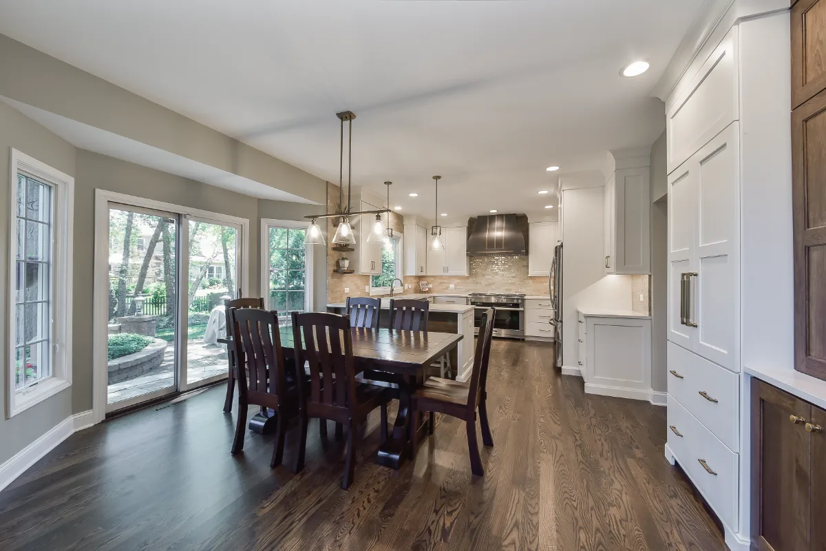 A transitional-organic kitchen remodel in Brentwood, TN. CWP Swiss Coffee and Hickory Praline cabinetry, Caesarstone Calacatta Nuvo quartz, and Delta Cassidy Champagne Bronze fixtures by Sebring Design Build.