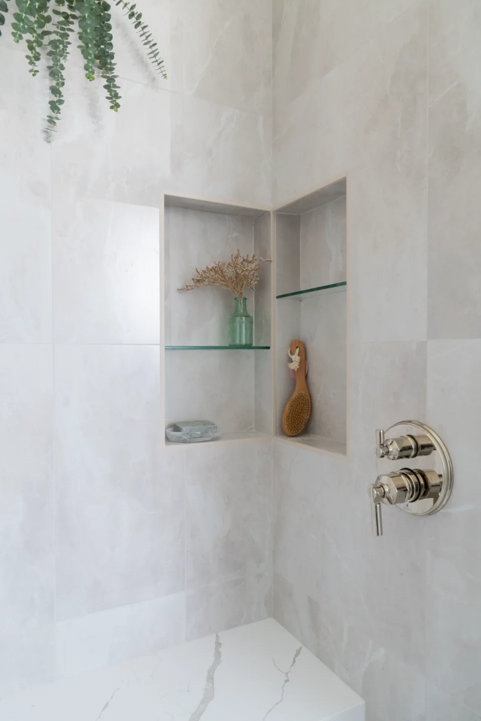 An elegant-classic primary bath in Willowsprings, Franklin TN 37064. CWP Walnut Natural Solid Wood Panel cabinetry, Mikado Calacatta Gold quartz, full Brizo Invari Polished Nickel fixture program, Gallery Pearl shower walls, and Empyrean Ice Blend.