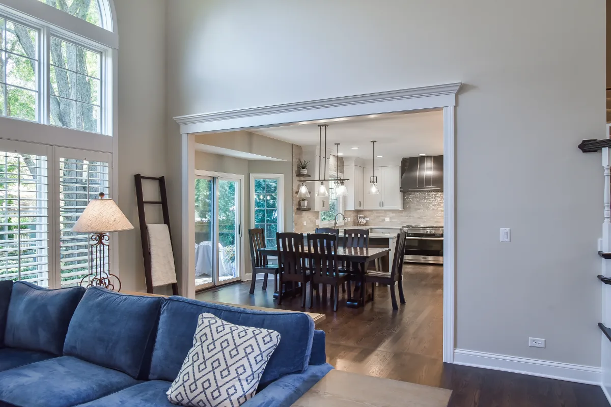 A transitional-organic kitchen remodel in Brentwood, TN. CWP Swiss Coffee and Hickory Praline cabinetry, Caesarstone Calacatta Nuvo quartz, and Delta Cassidy Champagne Bronze fixtures by Sebring Design Build.