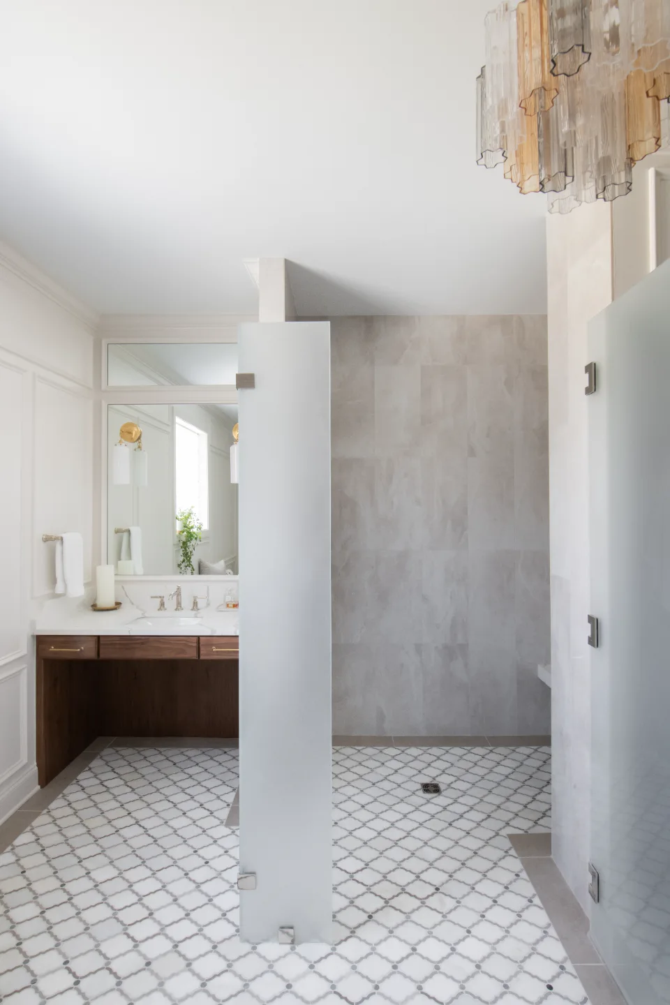 An elegant-classic primary bath in Willowsprings, Franklin TN 37064. CWP Walnut Natural Solid Wood Panel cabinetry, Mikado Calacatta Gold quartz, full Brizo Invari Polished Nickel fixture program, Gallery Pearl shower walls, and Empyrean Ice Blend.