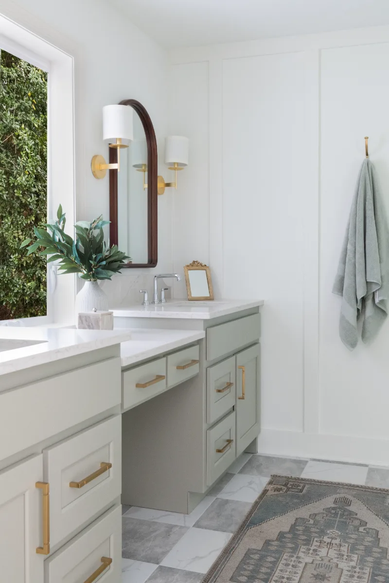 A modern-soft-luxurious primary bath in Leiper's Fork, TN 37069. CWP Mourning Dove Standard Overlay cabinetry, Metro Quartz Mystique scalloped countertops, Delta Chrome fixtures, and Carrera White 13x13 porcelain floor tile by Sebring Design Build.