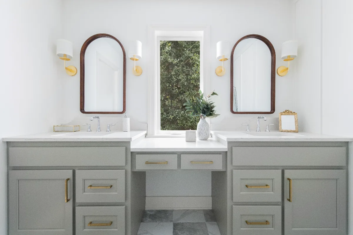 A modern-soft-luxurious primary bath in Leiper's Fork, TN 37069. CWP Mourning Dove Standard Overlay cabinetry, Metro Quartz Mystique scalloped countertops, Delta Chrome fixtures, and Carrera White 13x13 porcelain floor tile by Sebring Design Build.