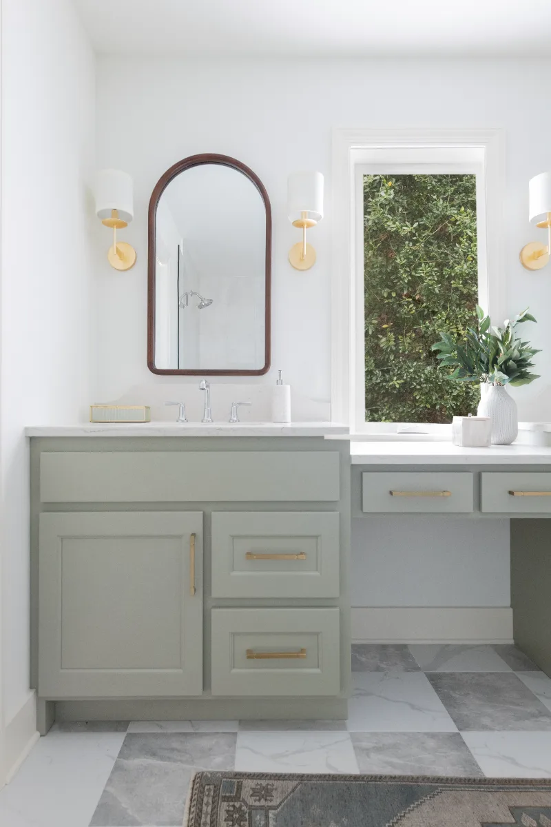 A modern-soft-luxurious primary bath in Leiper's Fork, TN 37069. CWP Mourning Dove Standard Overlay cabinetry, Metro Quartz Mystique scalloped countertops, Delta Chrome fixtures, and Carrera White 13x13 porcelain floor tile by Sebring Design Build.