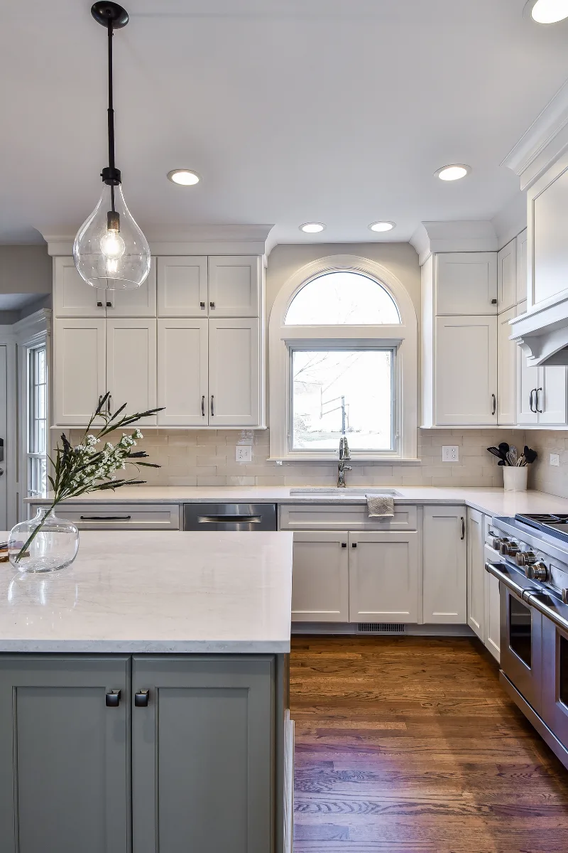 A refined-transitional kitchen remodel in Franklin, TN. CWP cabinetry in Soft White and Tarragon, Cambria Ironsbridge quartz, and Delta Cassidy Polished Nickel fixtures by Sebring Design Build.