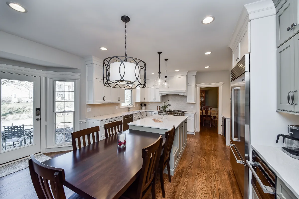 A transitional-refined kitchen in Franklin, TN. CWP Soft White and Tarragon Classic Square Recessed cabinetry, Cambria Ironsbridge Polished quartz, Delta Cassidy Polished Nickel faucet, and Sonoma Stellar Bossy Gray backsplash by Sebring Design.