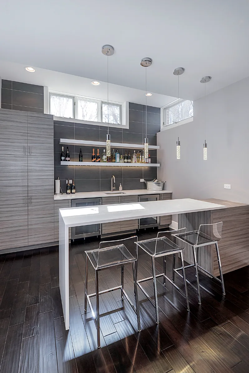 A modern-masculine basement remodel in Brentwood, TN with a dedicated bar, guest bath, and stage area by Sebring Design Build.