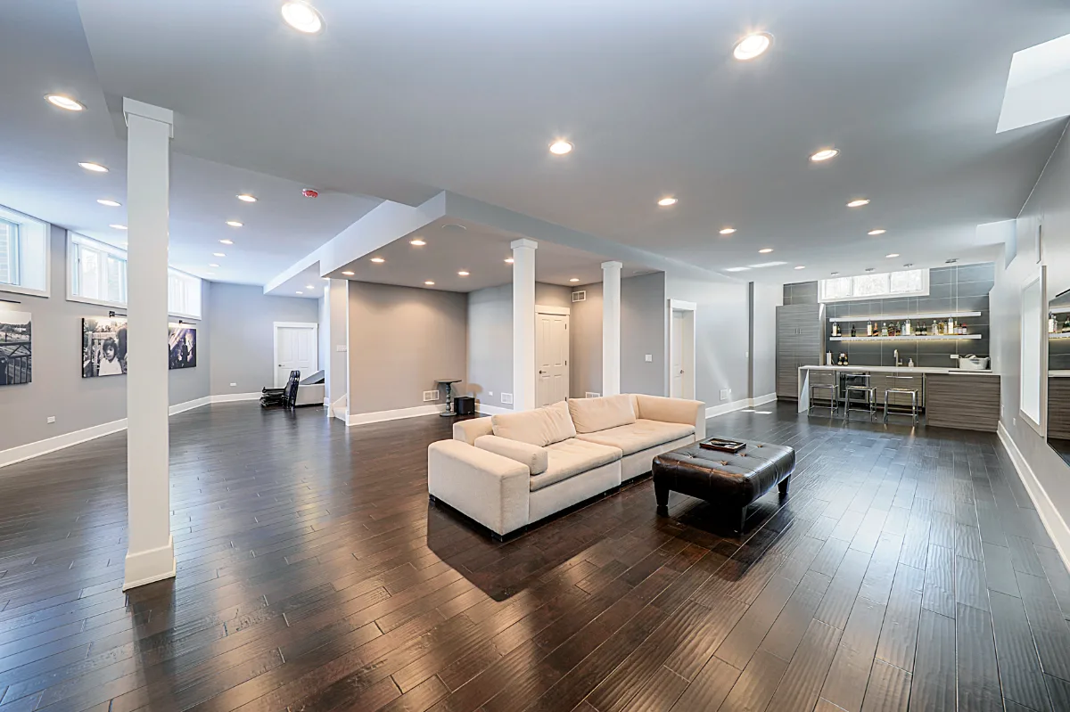 A modern-masculine finished basement in Brentwood, TN with a bar, guest bath, and stage by Sebring Design Build. Specs pending photo verification.