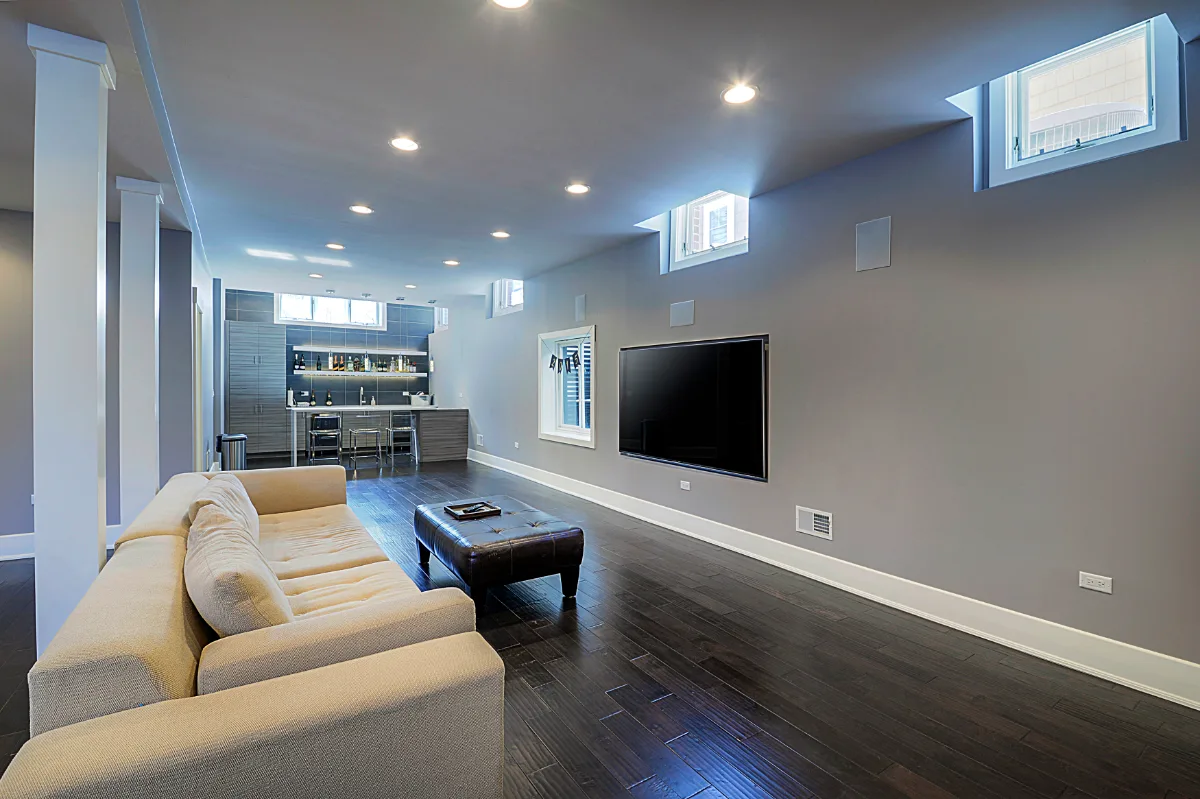 A modern-masculine finished basement in Brentwood, TN with a bar, guest bath, and stage by Sebring Design Build. Specs pending photo verification.