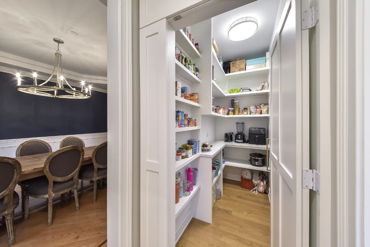 A modern-elegant pantry in Brentwood, TN. Soft White Shaker cabinetry and Corian Quartz Calcutta Natural countertops, coordinated with the kitchen remodel by Sebring Design Build.