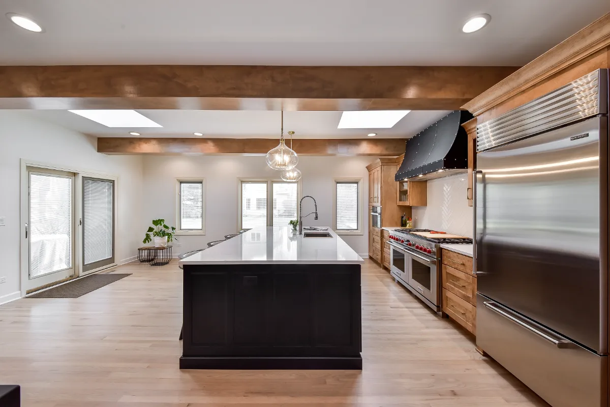 A modern-rustic kitchen in Brentwood, TN. CWP Fruitwood on Birch and Bunker Hill Black cabinetry, Cambria Charlestown Matte and Colton Polished quartz, Kohler Tournant faucet, and Ledger Stone Carbon backsplash by Sebring Design Build.