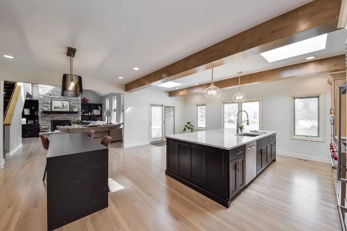 A modern-rustic kitchen in Brentwood, TN. CWP Fruitwood on Birch and Bunker Hill Black cabinetry, Cambria Charlestown Matte and Colton Polished quartz, Kohler Tournant faucet, and Ledger Stone Carbon backsplash by Sebring Design Build.